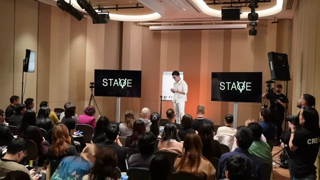 The speaker engaging with the audience during a workshop, sharing a personal story about his entrepreneurial journey.