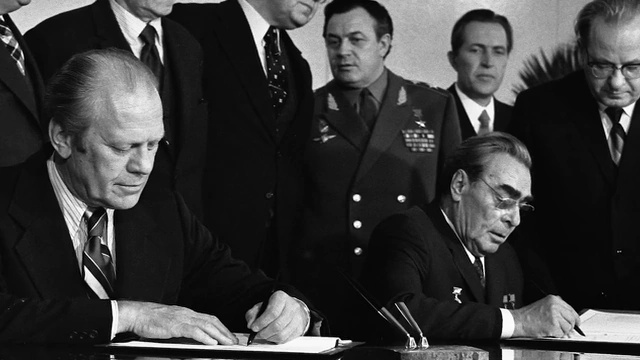 Image of President Ford and Leonid Brezhnev signing a treaty, used as an analogy for the AI-orchestrated peace.