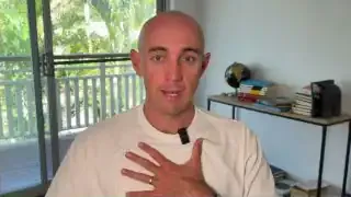 Man places his hand over his heart, demonstrating a technique for presence and self-calming.