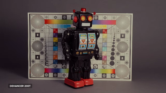 A comparison showing the warm tint of Dehancer's Kodak 200T preset, which is described as inaccurate for tungsten-balanced stock, with a color chart and robot.