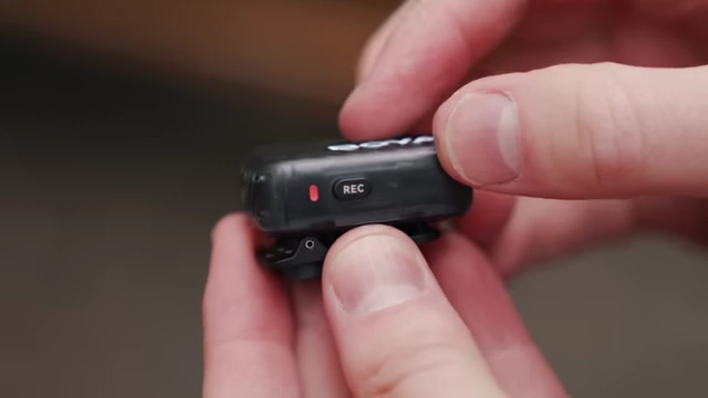Close-up of the Boya Mic 2 transmitter with a visible 'REC' button, indicating internal recording.