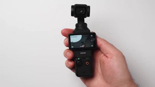 Comparison shot of the DJI Mic 3 transmitter next to a DJI Osmo Pocket 3.