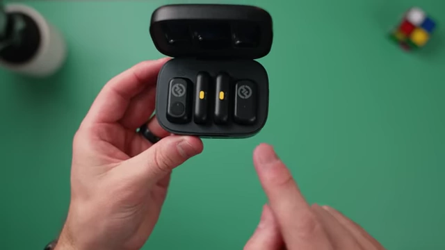 The HollyLand Lark A1 charging case showing two transmitters with yellow LED indicators.