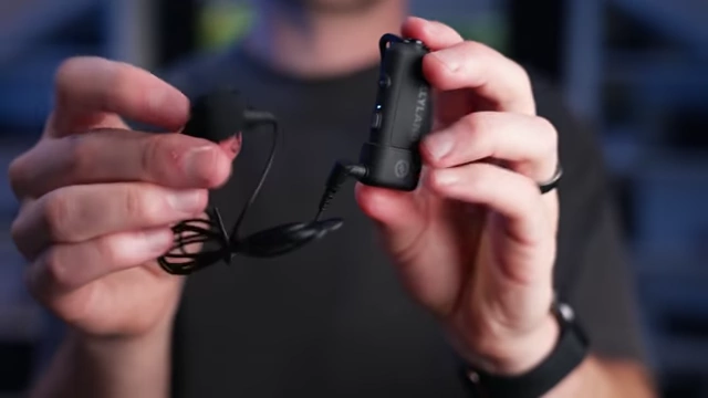 The HollyLand Lark MAX 2 transmitter with its 3.5mm adapter and an attached lapel microphone.