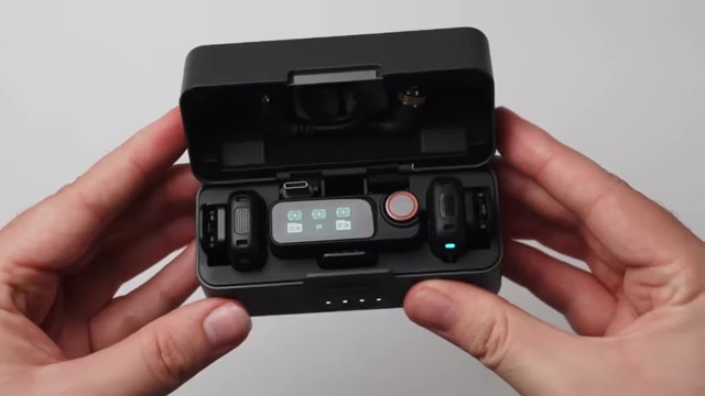 The DJI Mic 3 charging case with transmitters, receiver, and windscreens stored.