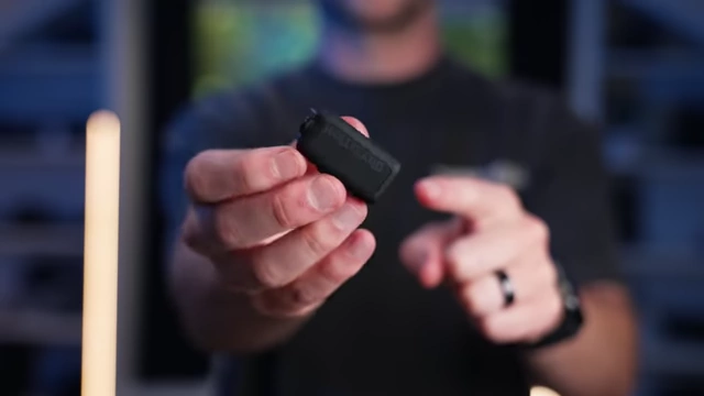 The HollyLand Lark MAX 2 transmitter being held by the reviewer.