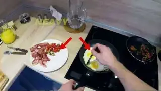 A person preparing a large English breakfast with eggs and bacon