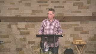 Pastor David Graham delivering a sermon from the pulpit