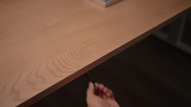 Retractable USB-C cable extended from under the desk