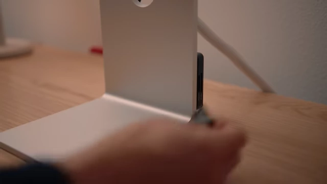 Card reader inserted into the monitor stand's crevice, secured with tape