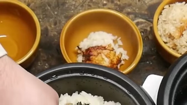 Cooked sake rice with a noticeable burnt crust at the bottom.