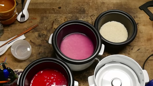 Three rice cookers with Faygo Red Pop, Gamer Supps, and plain rice ready for beer.