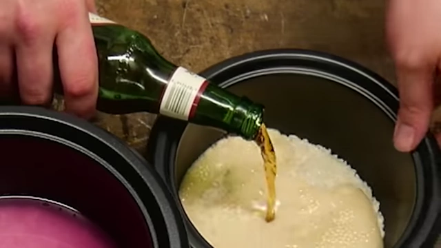 Pouring Yuengling beer into a rice cooker with rice.