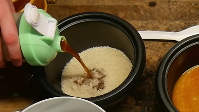 Pouring dark instant coffee mixture into rice.