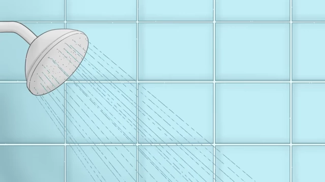 A shower head spraying water, representing the pre-swim showering routine.