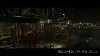 A wide shot of three Spider-Men in a complex scaffolding structure within a large setting.