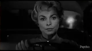 A close-up shot of a woman's face as she drives, emphasizing her expression.