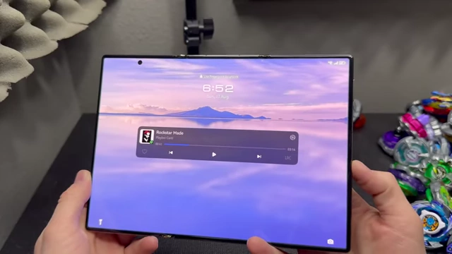 The media player widget displayed prominently on the lock screen of the Huawei Mate XT, showing track controls and remaining time.