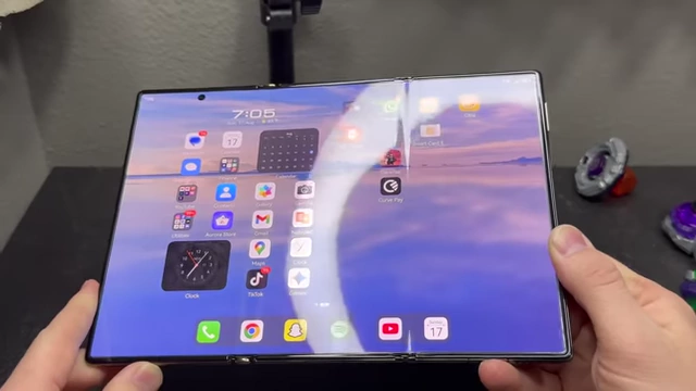 The unfolded screen of the Huawei Mate XT clearly shows two horizontal creases across its display, a result of its trifold design.