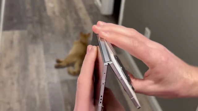 A person's hands demonstrating the dual-hinge mechanism of the Huawei Mate XT.