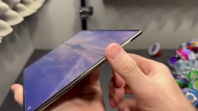 A finger placed on the side-mounted fingerprint scanner, highlighting its omnidirectional recognition capability.