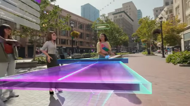 People play virtual pingpong in a metaverse-style street scene.