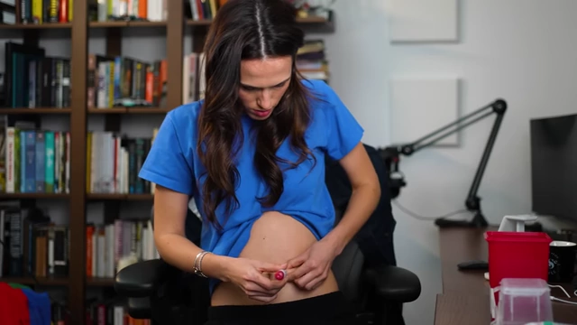 A person demonstrating self-injection of hormones into their abdomen