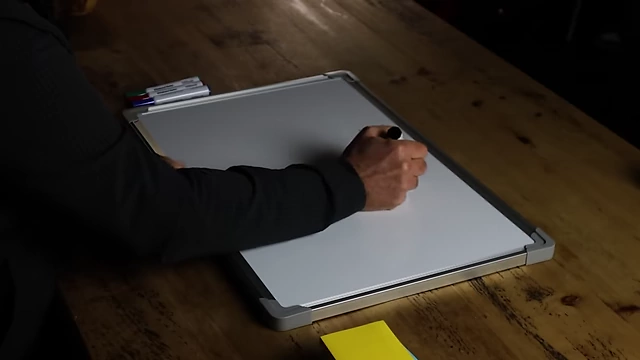 The speaker writing "what you like doing" on a whiteboard.