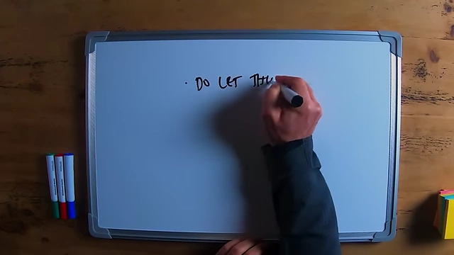The speaker writing "do let things own you" on a whiteboard, which he corrects to "don't let things own you".