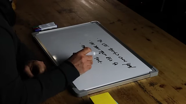The speaker writing "take your time" on a whiteboard.