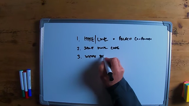 The speaker writing "what this person looks like" on a whiteboard.