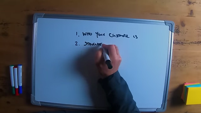 The speaker writing "staircase philosophy" on a whiteboard.