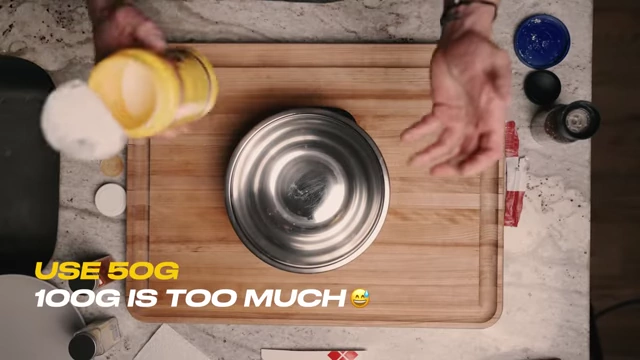 Adding cornstarch to a bowl, with a note correcting the measurement to 50g