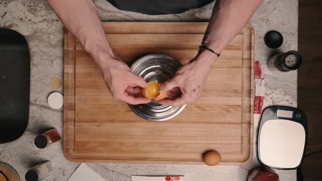 Separating egg whites into a bowl for the egg wash