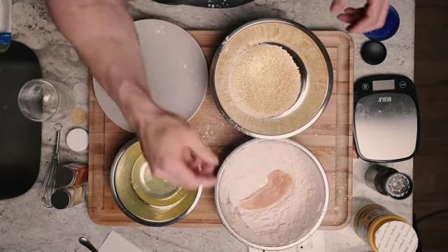 Dusting a chicken tender in the spiced cornstarch mix