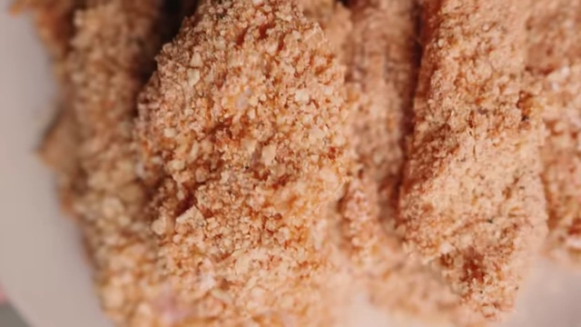Close-up of multiple chicken tenders fully coated and ready for cooking