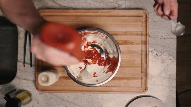 Squeezing low-calorie ketchup into the bowl with Greek yogurt