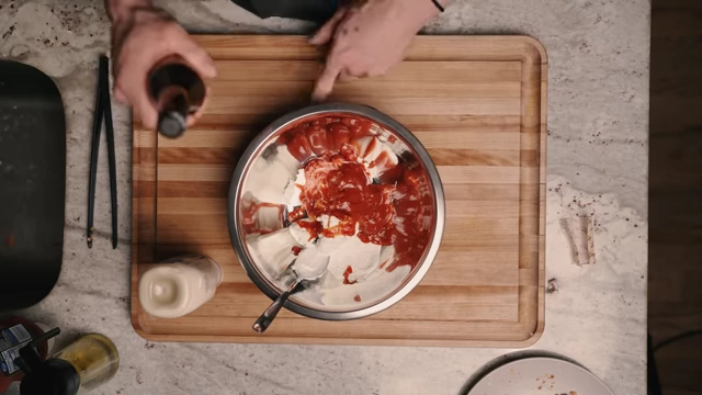 Pouring Worcestershire sauce into the sauce mixture