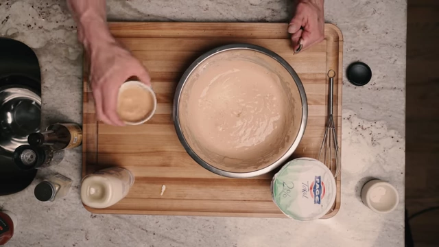 Two bowls displaying the finished Greek yogurt and light mayonnaise versions of the low-calorie Cane's sauce