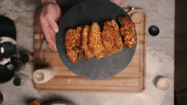A platter of crispy air-fried chicken tenders and low-calorie sauces