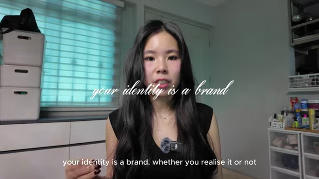 The speaker discusses how personal identity functions as a brand that needs to be defined intentionally.