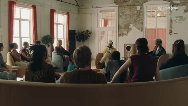 Tyler, The Creator sits with a group of creatives in a semi-circle discussion