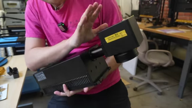 The Commarker Omni 1 DPSS UV laser held by the speaker