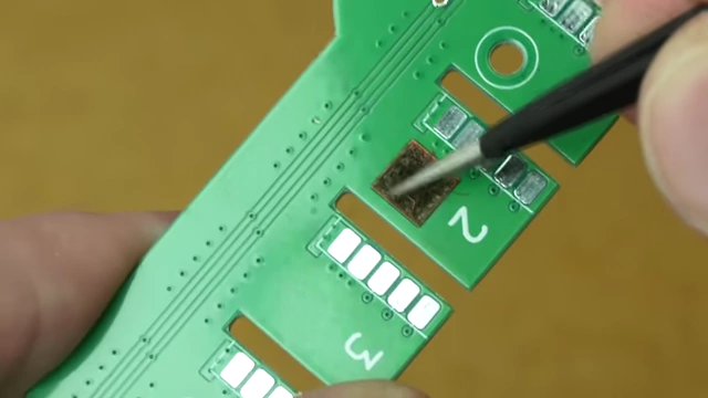 Close-up showing conductive residue left on FR4 by a fiber laser, causing shorts