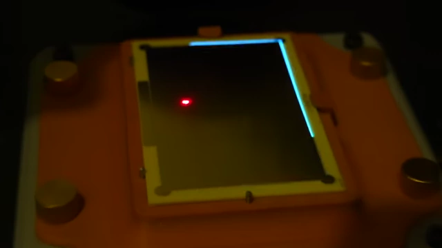 Laser highlighting the "Pac-Man" alignment features on the PCB for precise positioning