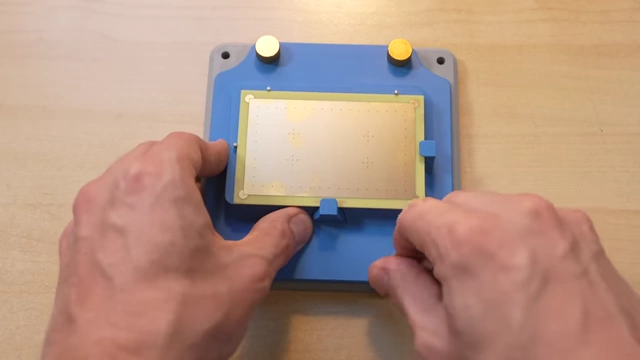 Adjusting the top plate of the alignment jig to precisely align the PCB