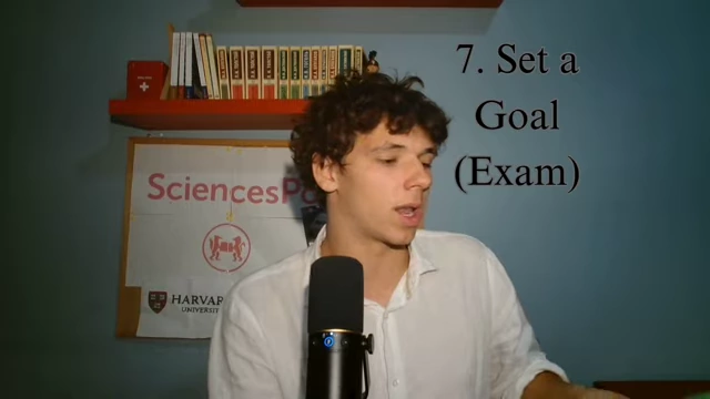 The speaker displays an exam preparation book for the C1 DELE in Spanish.