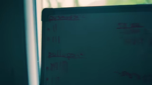 Whiteboard tracking daily workout reps and completion