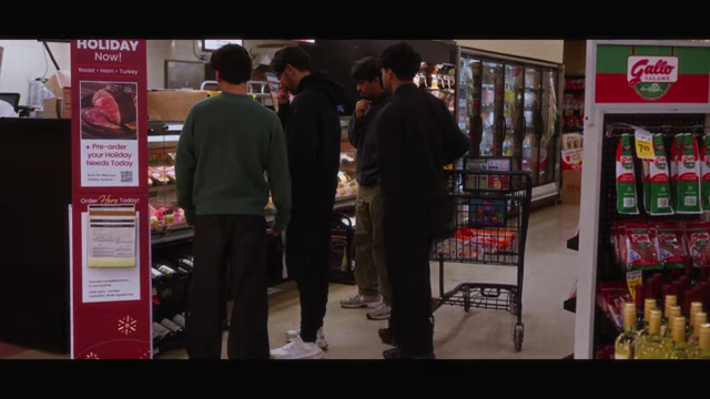 The team browsing aisles in a grocery store for supplies
