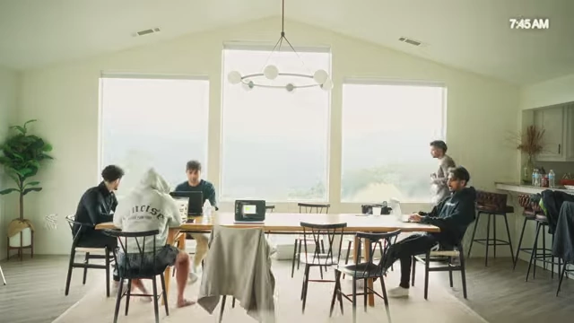 The team seated at a dining table with a scenic view outside